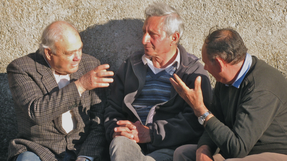 Three men sitting and talking